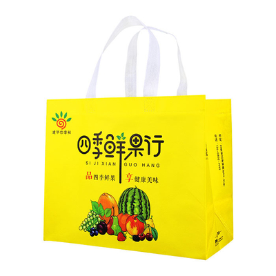 黄色い105gsmバージンの食料雑貨品店のために薄板になる注文の印刷されたポリプロピレン非編まれた袋